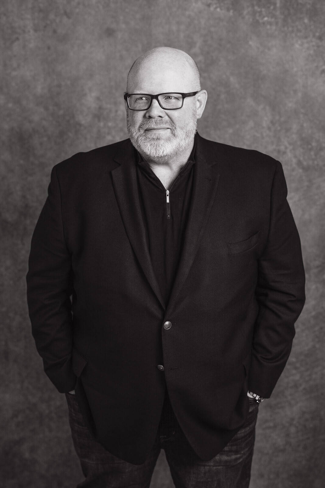 Man in black jacket with hands in pocket
