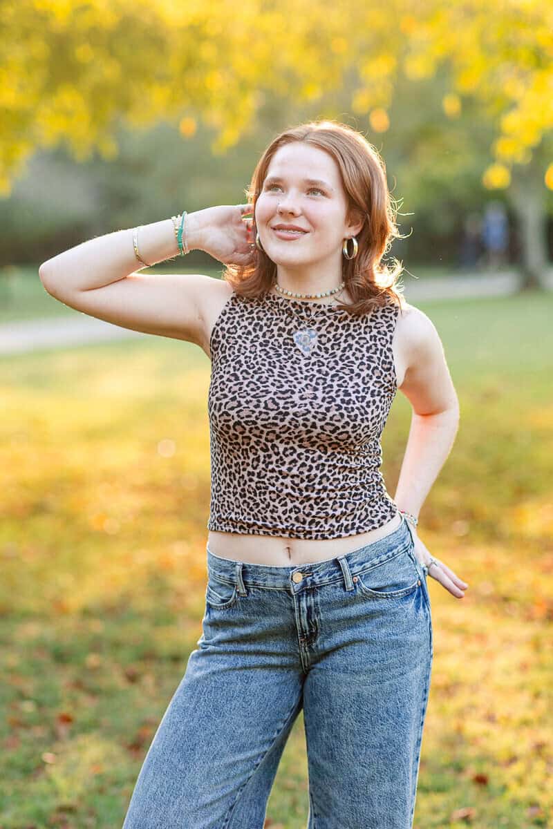 teenage girl poses with hand behind her head