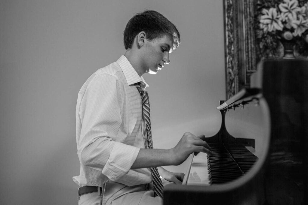 Young man seated at piano