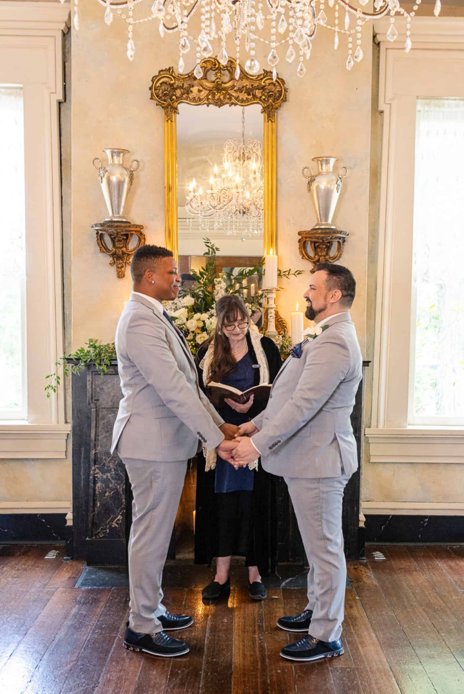 Same-sex male couple exchange vows inside historic mansion
