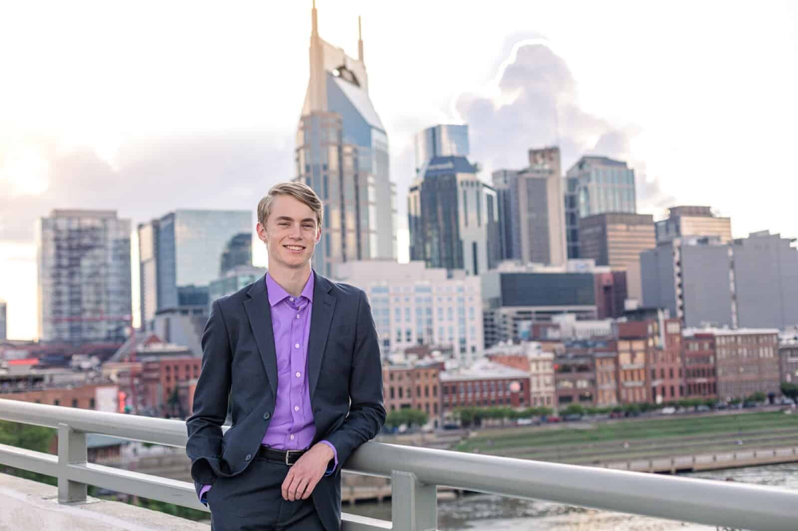 high school senior boy in suit with Nashville skyline