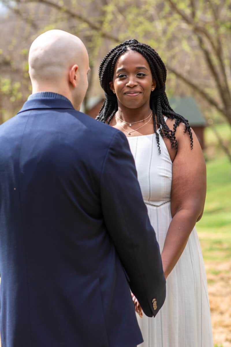 Spring Nashville Elopement at Butterfly Hollow; bride smiling at groom during ceremony