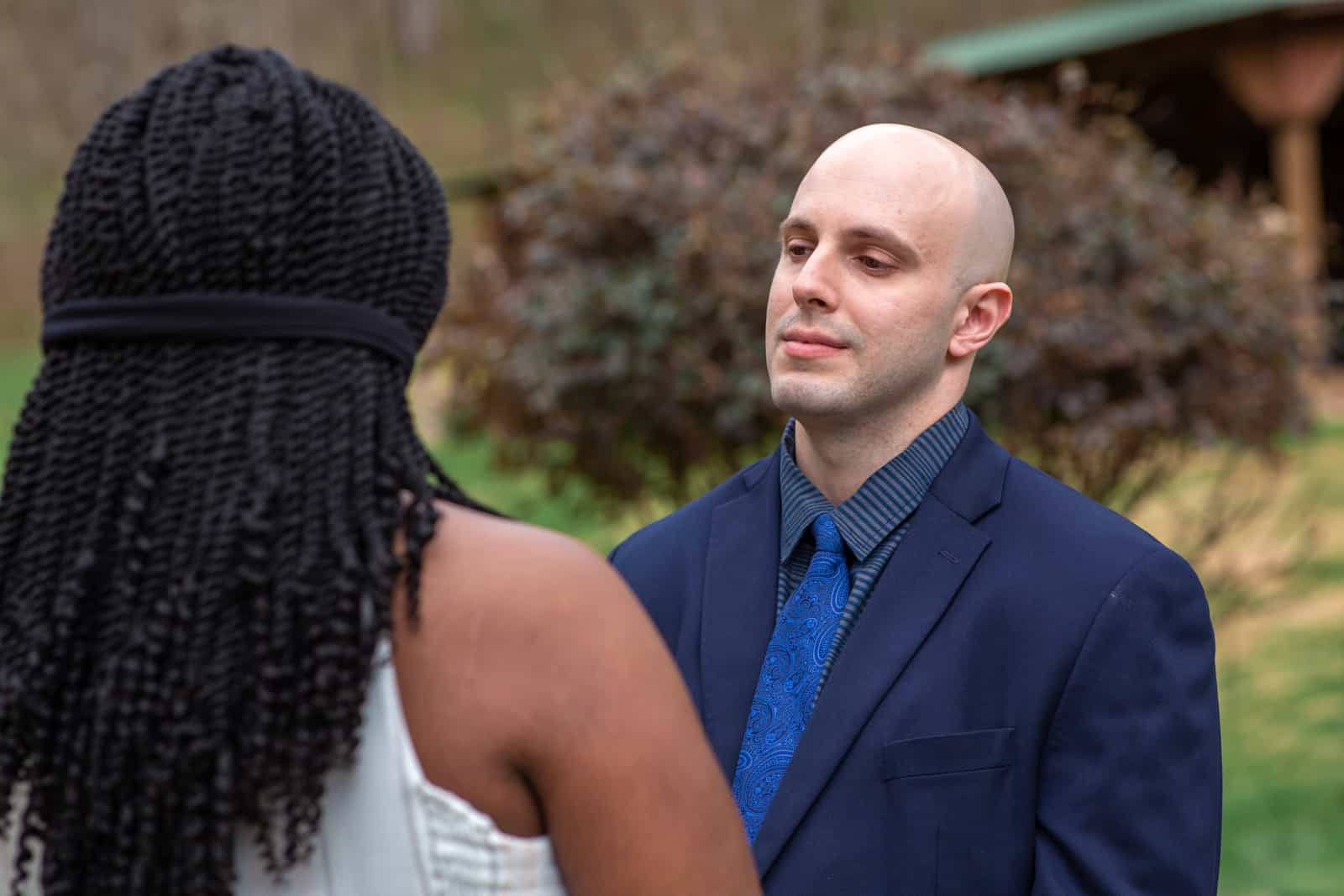Spring Nashville Elopement at Butterfly Hollow; groom smiling at bride during ceremony