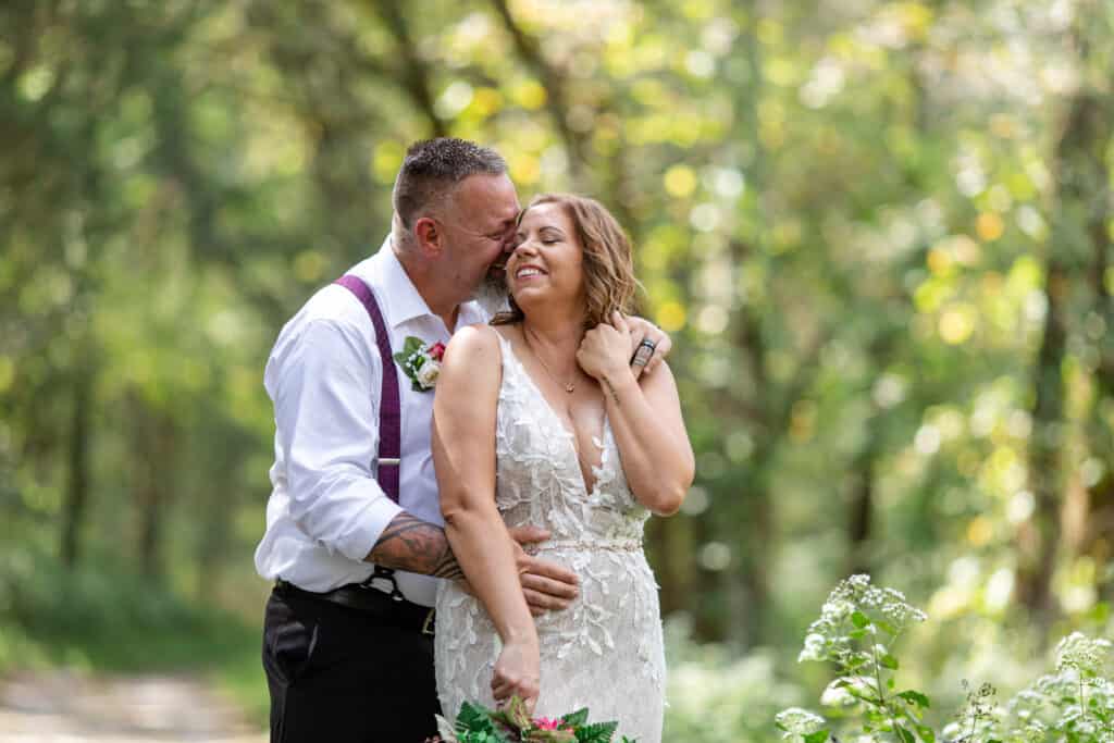 elopement bride and groom giggling in wooded area