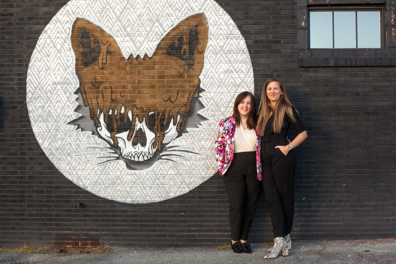LGBTQ couple portrait in front of Fox Mural