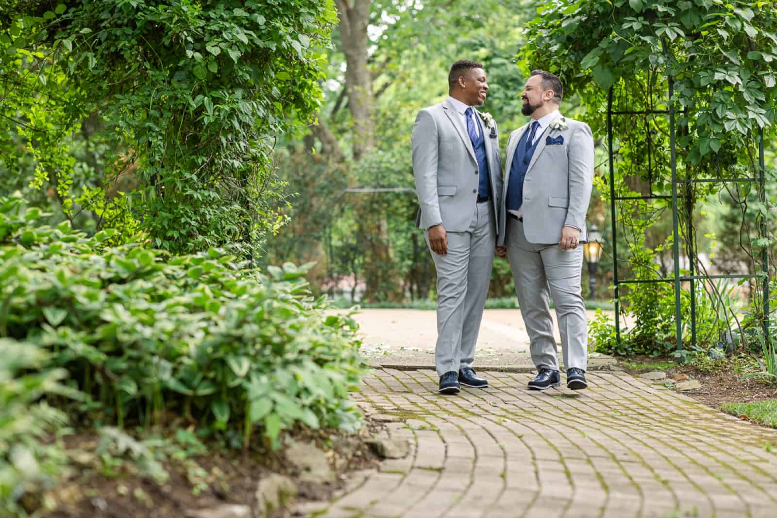 Male same-sex couple walking in garden