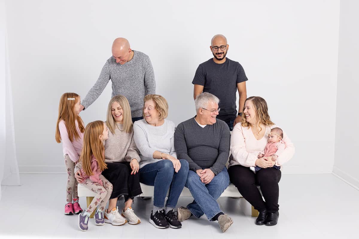 Large family laughing in studio for portrait session