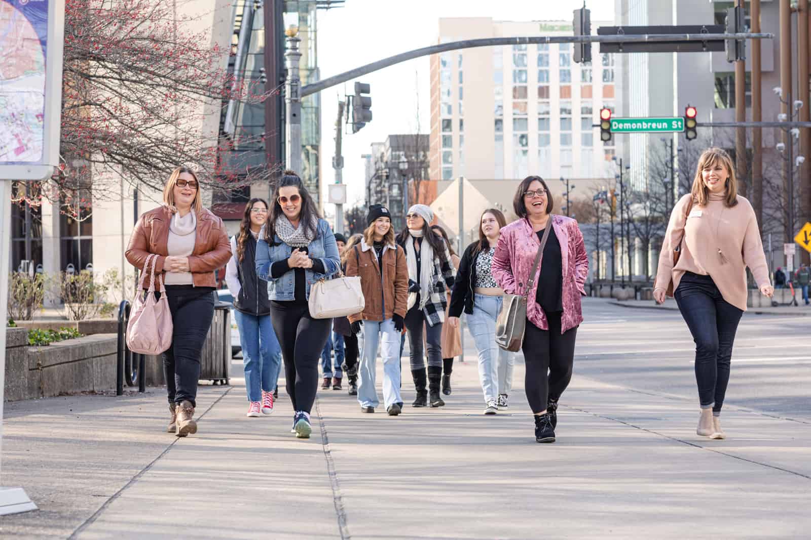 Group of women on a tour walking up urban street.