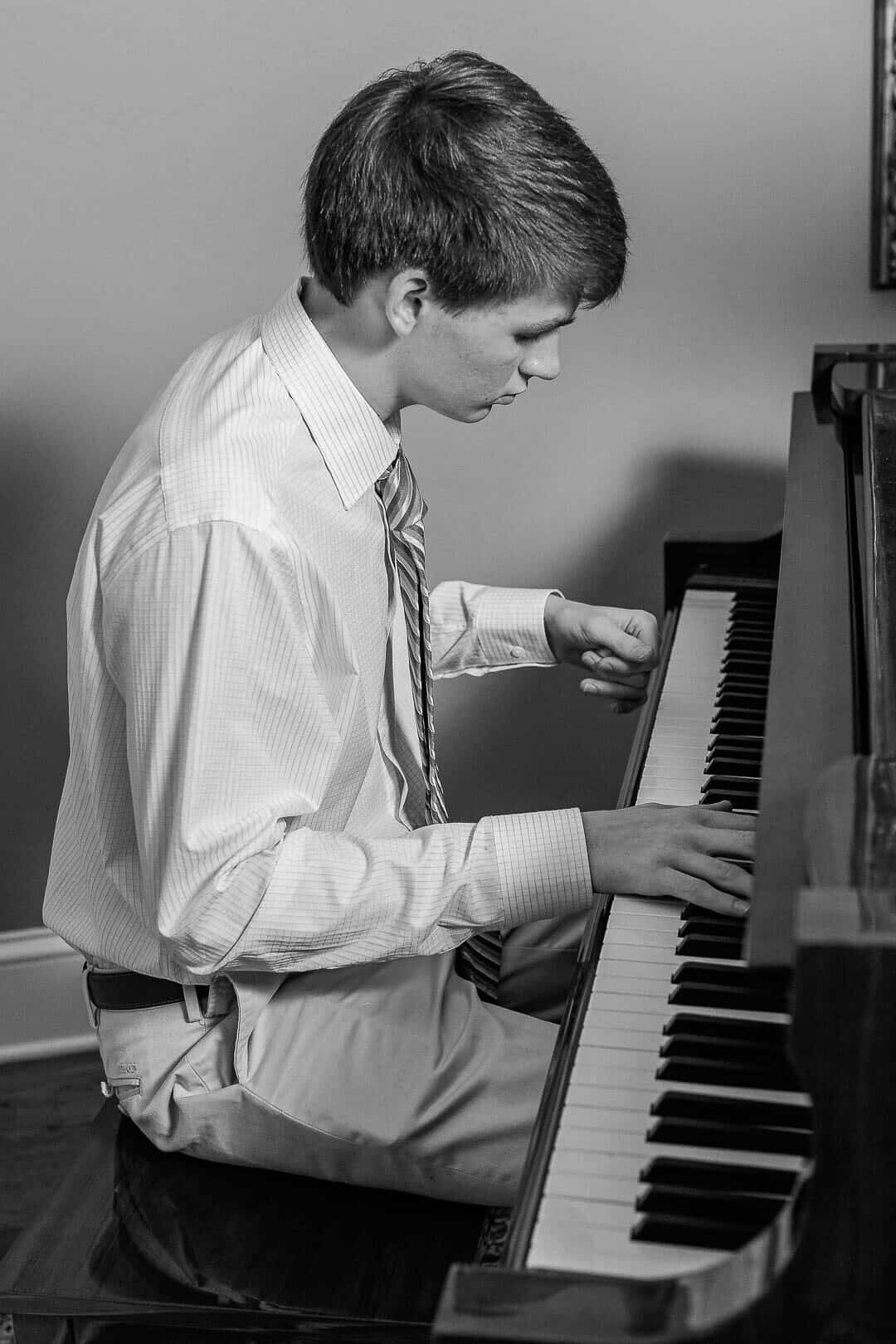 High School boy plays piano