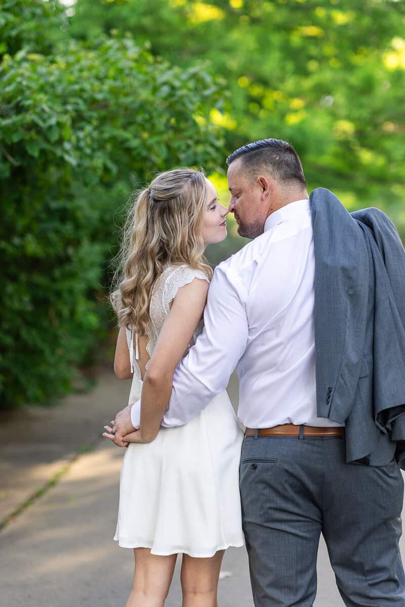 Bride and groom share a romantic embrace as they walk together