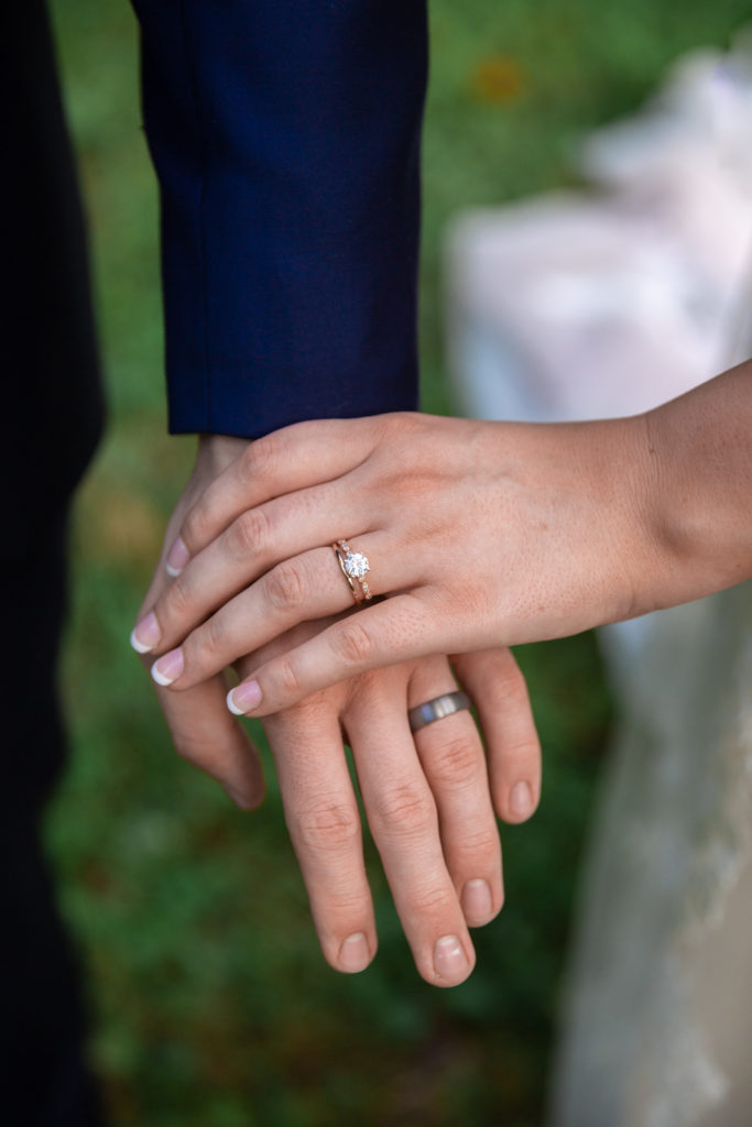 bride and groom with wedding rings