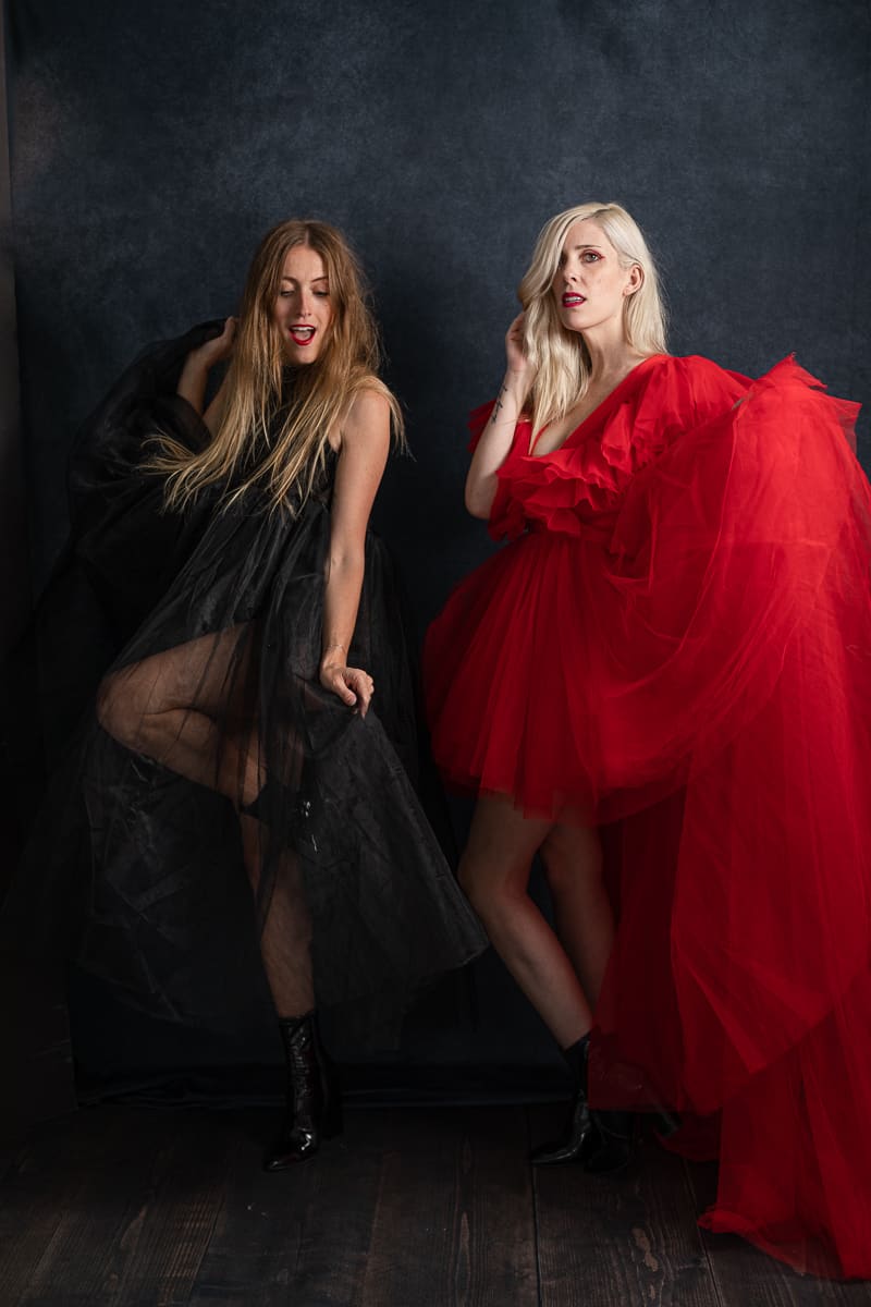 two models in sheer tulle black and red