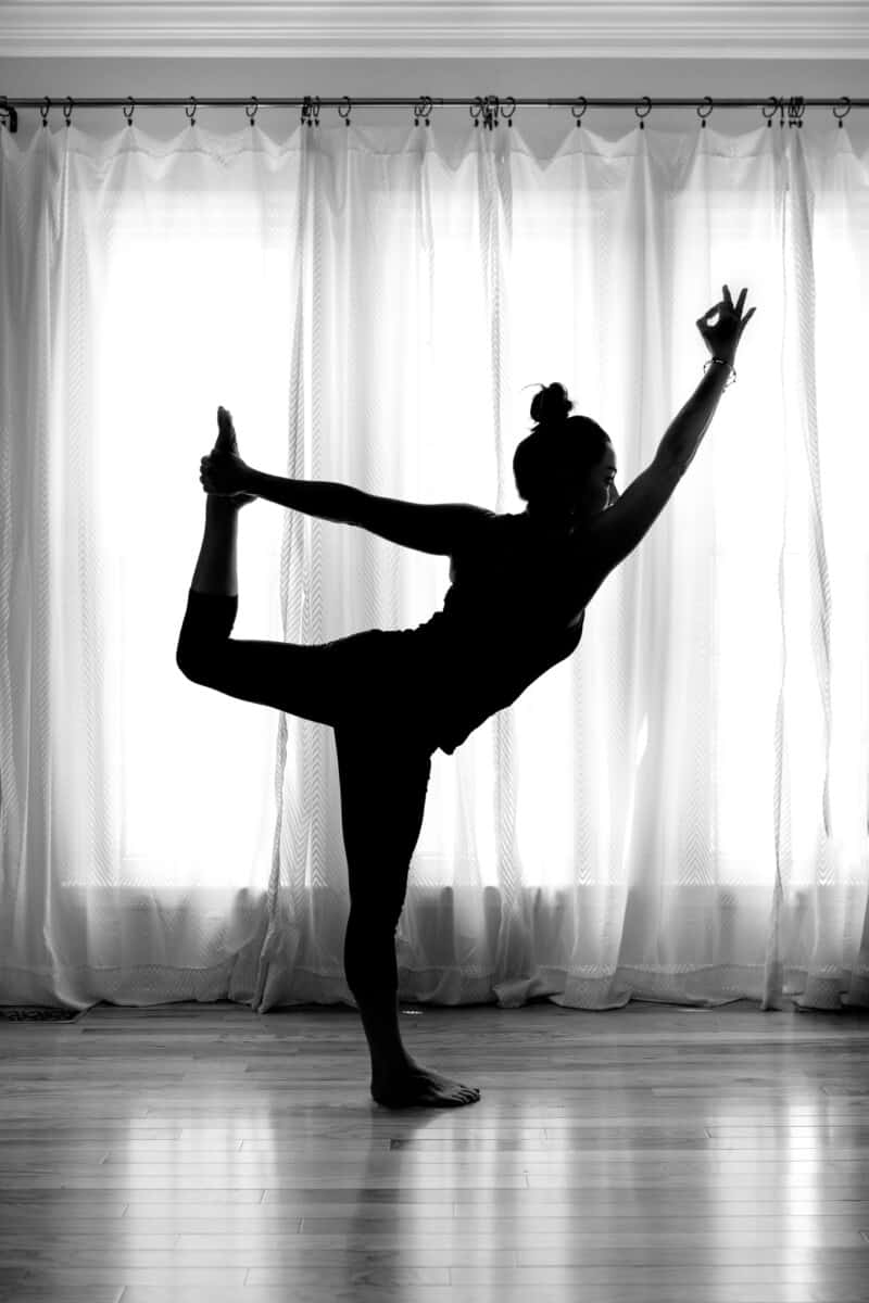 sillhouette of yoga teacher demonstrating dancer pose