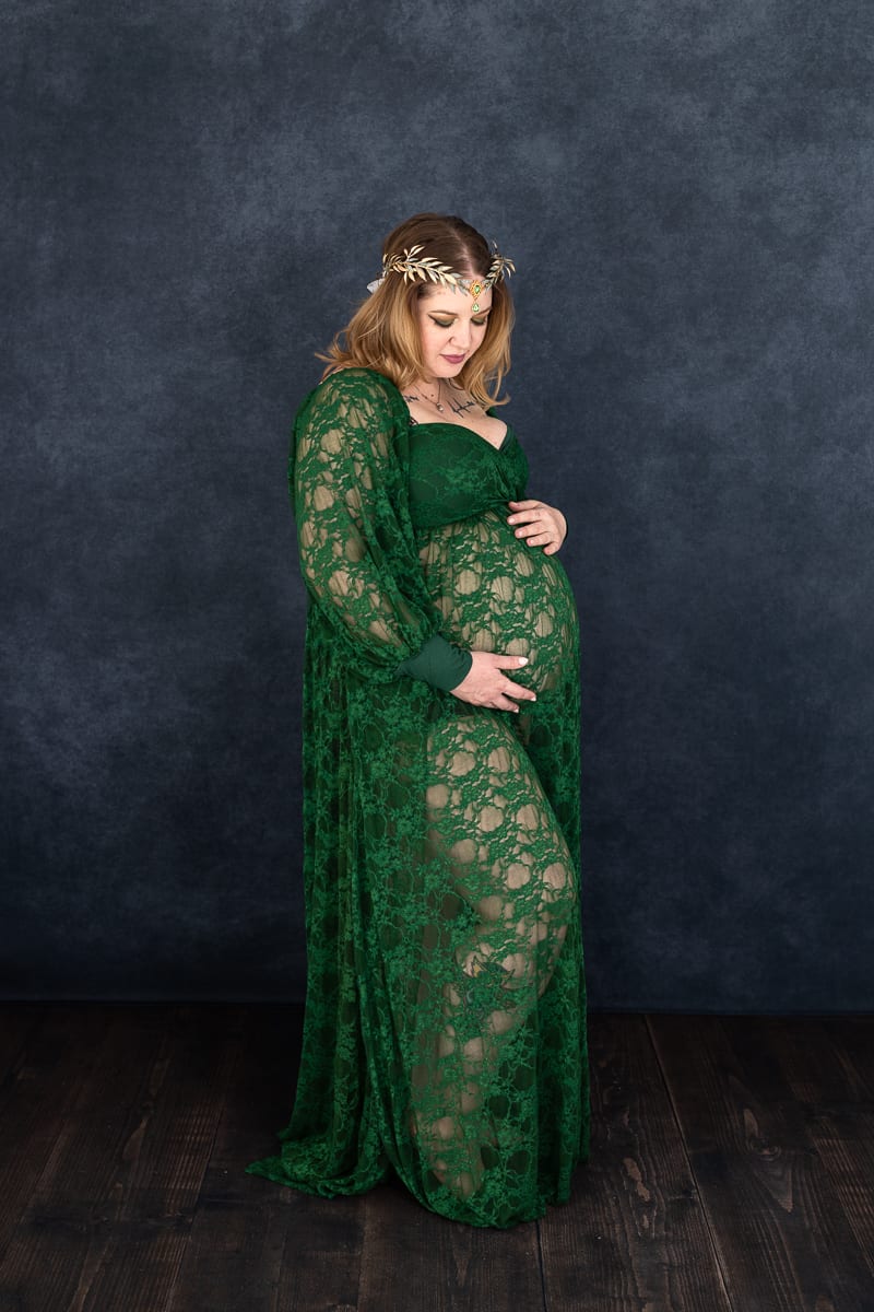 pregnant woman in lacy green dress and headdress